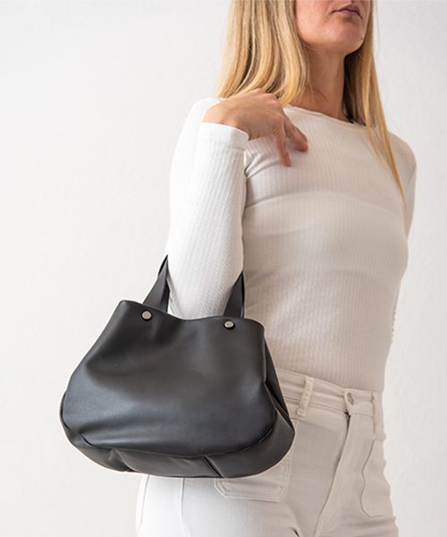 Borsa Tita, graziosa e capiente realizzata in nappa, colore nero. Indossata a mano.